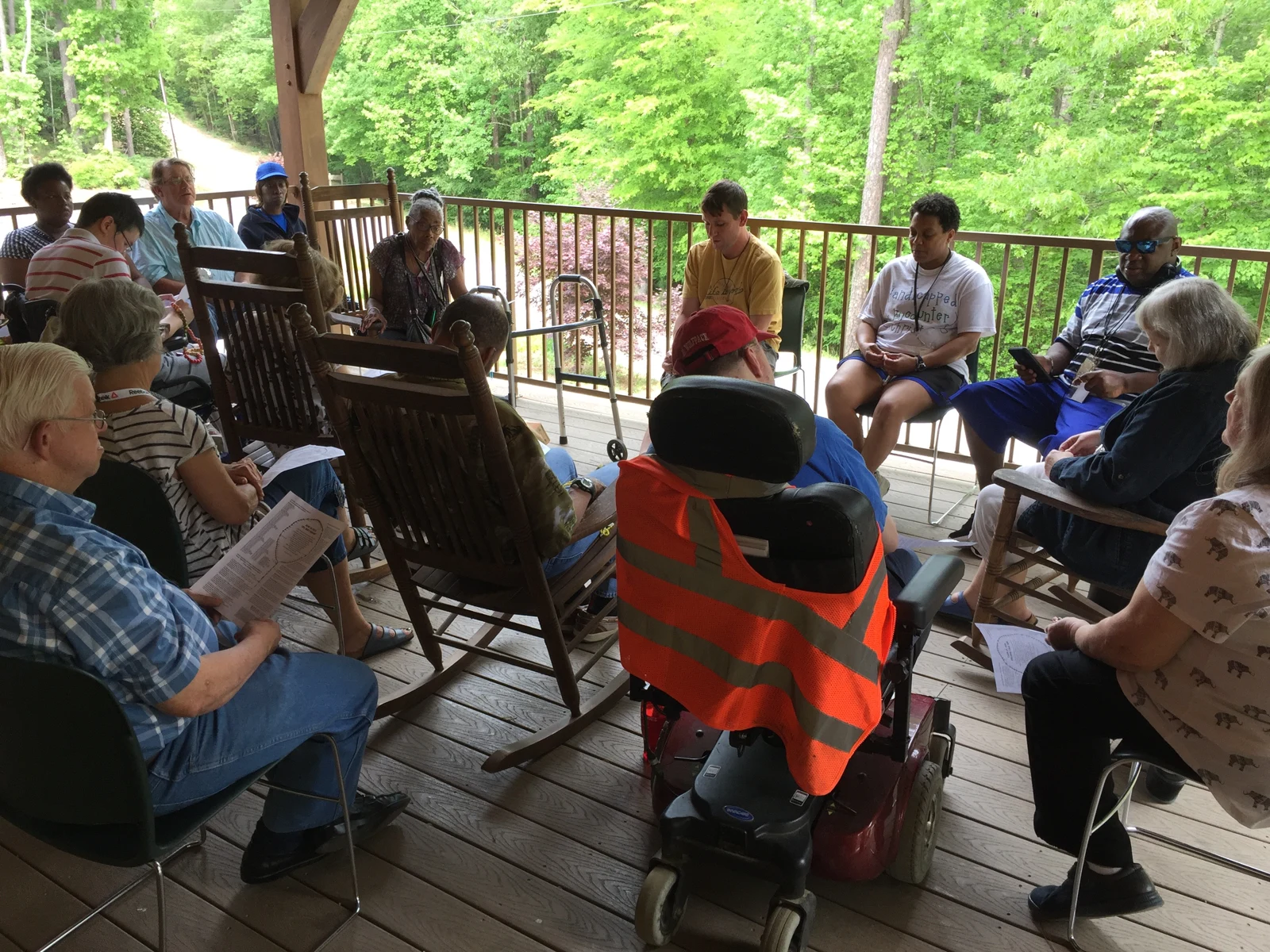 HEC friends gathering on a shaded outdoor porch